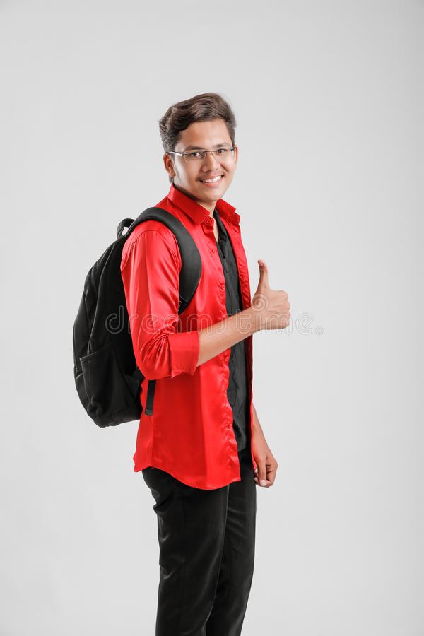 young-indian-college-boy-handsome-asian-male-student-carrying-bag-showing-thumps-up-155589607